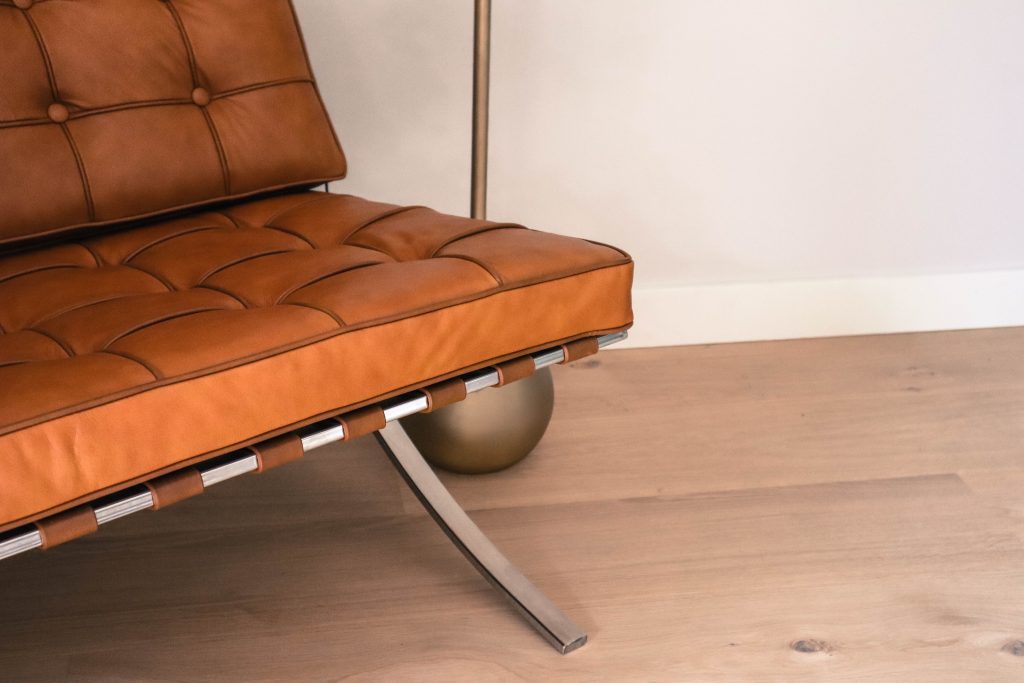 Bruine leren stoel op houten vloer.